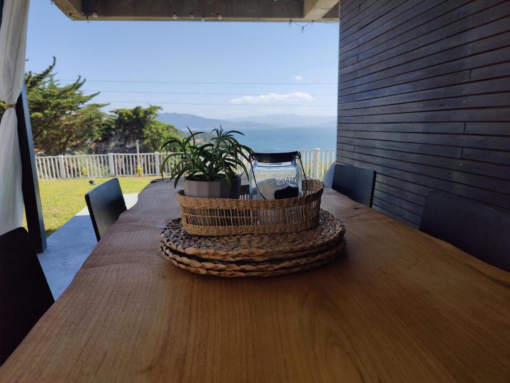 a wooden table with a basket on top of it at Apartamento mirador a las Islas Cíes in Cangas de Morrazo
