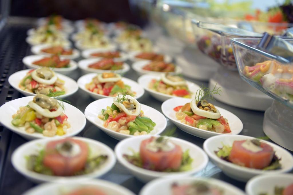 a bunch of plates of food on a table at Mirfa Hotel in Al Mirfa