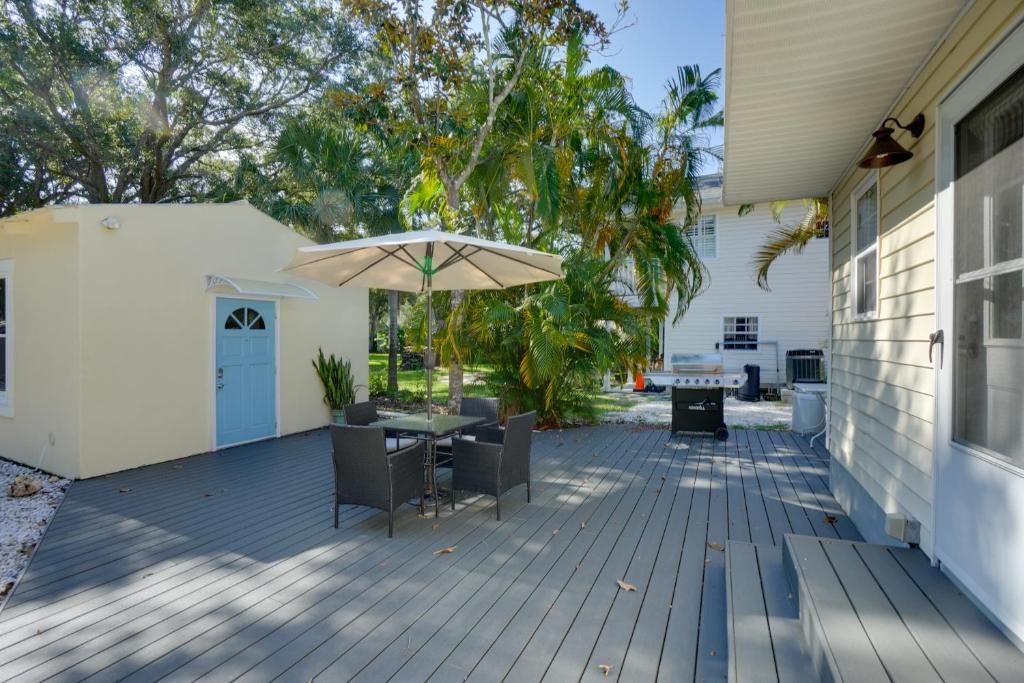 a patio with a table and an umbrella at Ozona Studio with Shared Deck - Steps to Gulf! in Palm Harbor