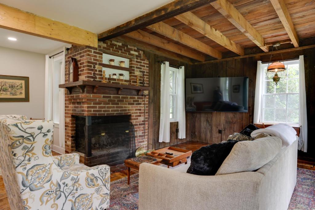 a living room with a couch and a fireplace at Historic Erwinna Vacation Home Near Delaware River in Point Pleasant