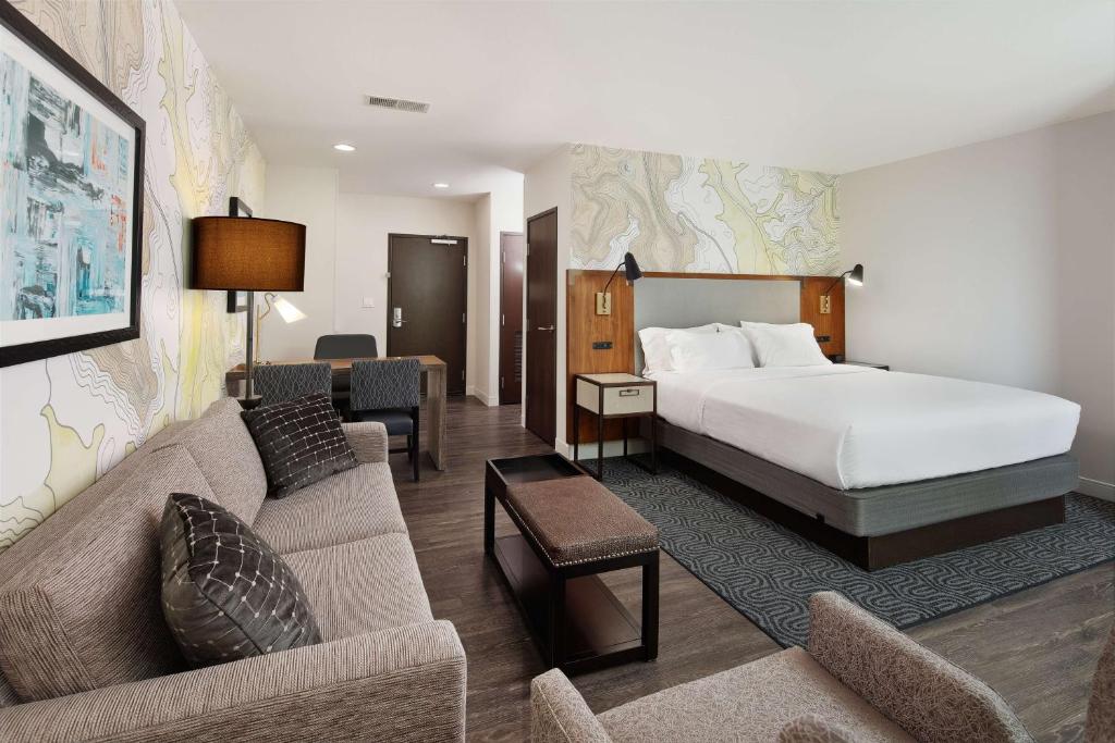 Habitación de hotel con cama y sofá en Embassy Suites Amarillo Downtown, en Amarillo
