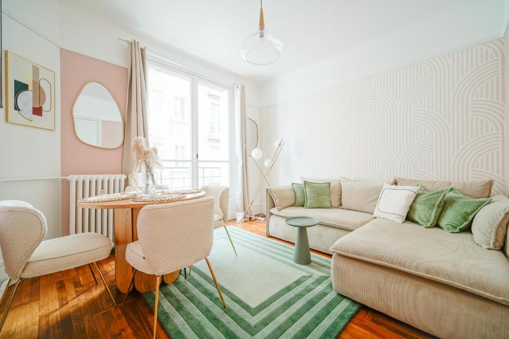 a living room with a couch and a table at Apartment next to Louis Vuitton Fondation in Neuilly-sur-Seine