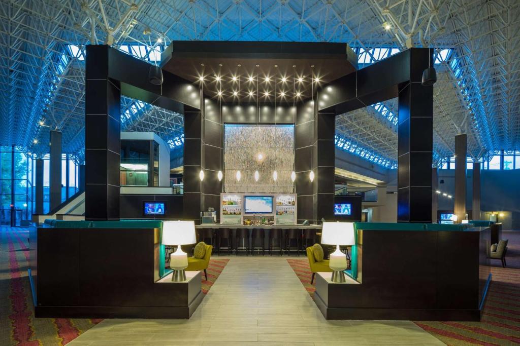 a lobby with a bar in a building at DoubleTree by Hilton Austin Northwest - Arboretum in Austin