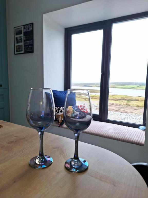two wine glasses sitting on top of a table at Teach Aindí (newly renovated cottage) in Belmullet