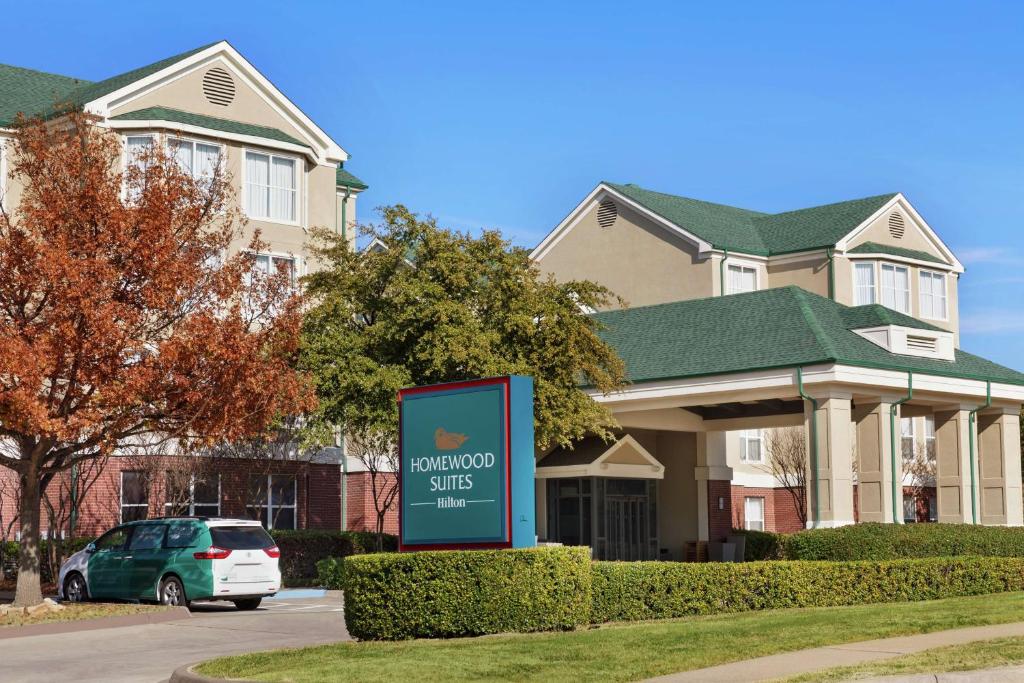 a house with a sign in front of it at Homewood Suites by Hilton Dallas-Plano in Plano