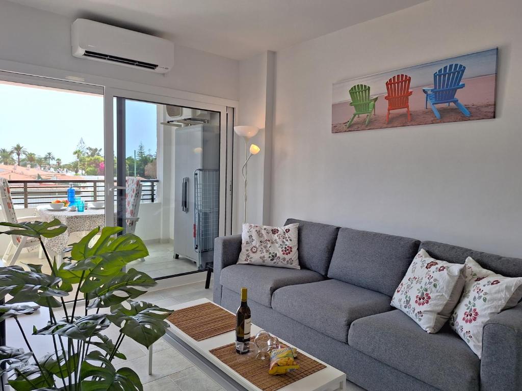 ein Wohnzimmer mit einem Sofa und einem Tisch in der Unterkunft Joya de Iguazu - Centrum Playa del Inglés in Maspalomas