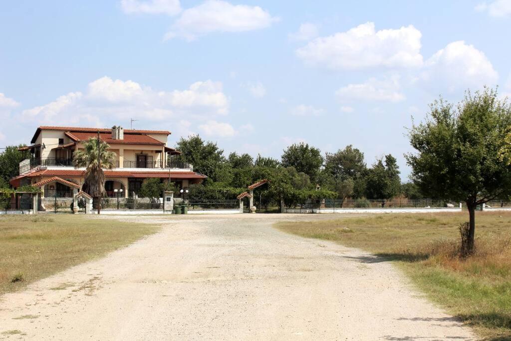 a dirt road in front of a house at Villa Apartment with 3 bedrooms in Polykastro