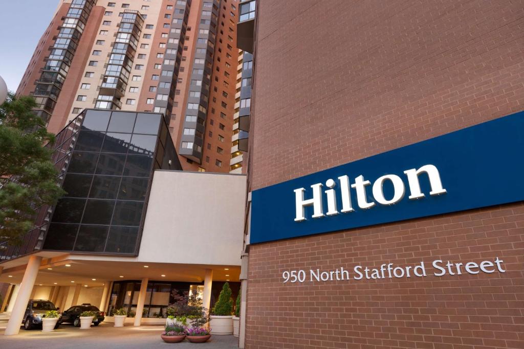 a building with a nittion sign on it at Hilton Arlington in Arlington