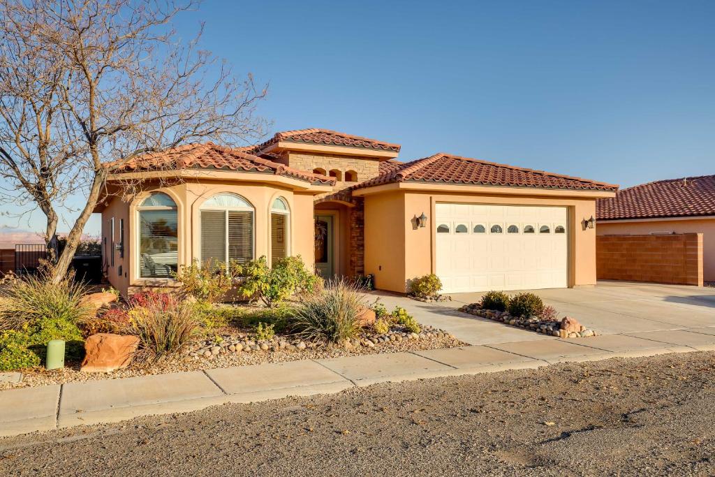 a house with a driveway and a garage at Horseshoe Bend Retreat with Fire Pit, Patio and Mtn Views in Page