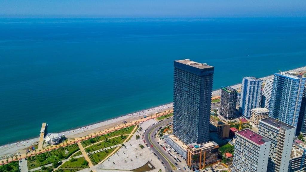 an aerial view of a tall building next to the ocean at Apartment in Orbi Beach Tower in Batumi