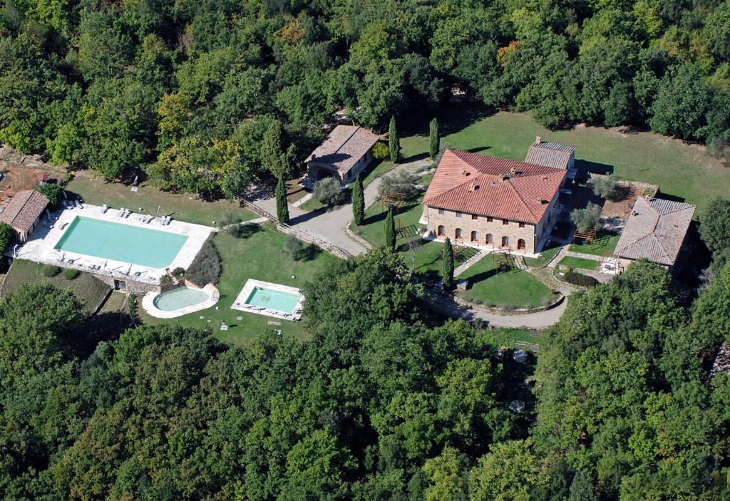 an aerial view of a house with a swimming pool at Borgo Mulignone in Casole dʼElsa