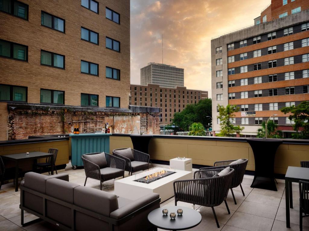 a rooftop patio with furniture and a view of a city at Canopy by Hilton New Orleans Downtown in New Orleans