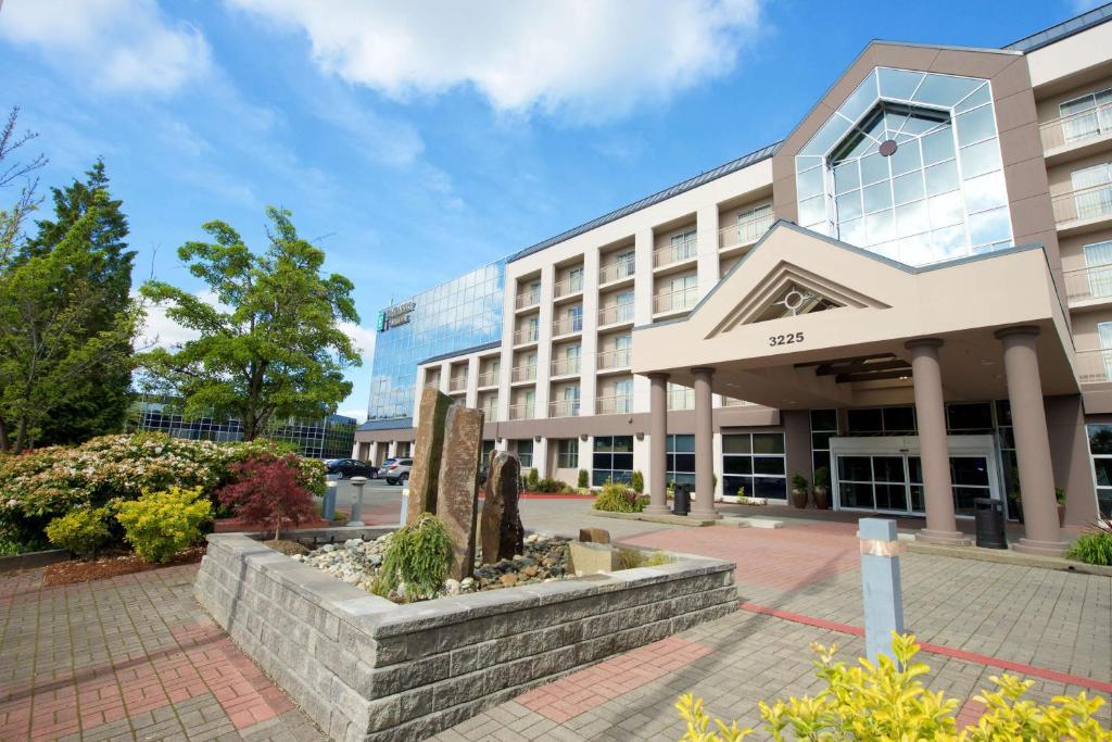 an office building with a courtyard in front of it at Embassy Suites by Hilton Seattle Bellevue in Bellevue