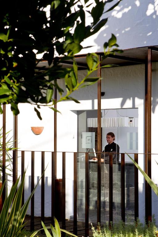 a man standing at a counter in a building at Hotel Boutique Ses Pitreras in San Antonio Bay