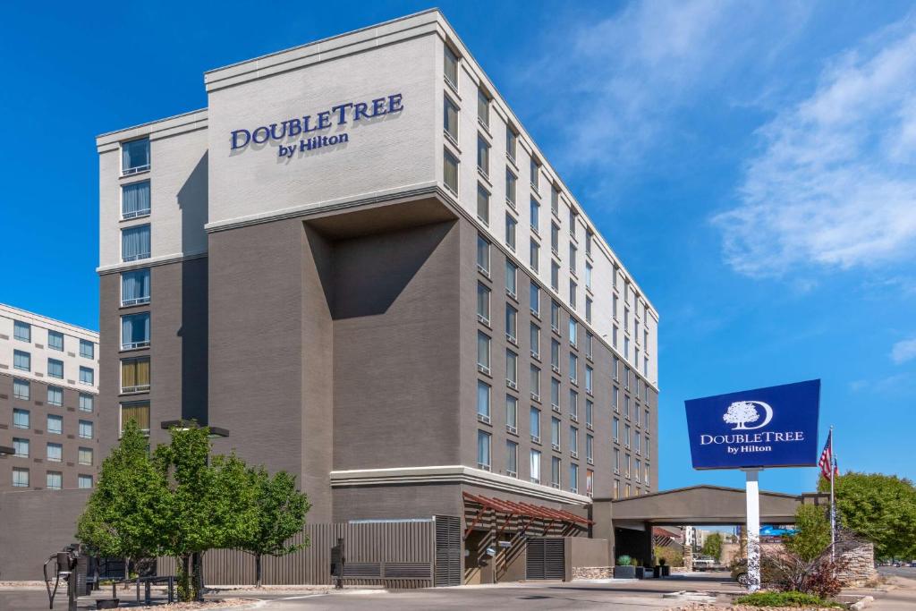 a building with a sign on the side of it at DoubleTree by Hilton Denver Cherry Creek, CO in Denver