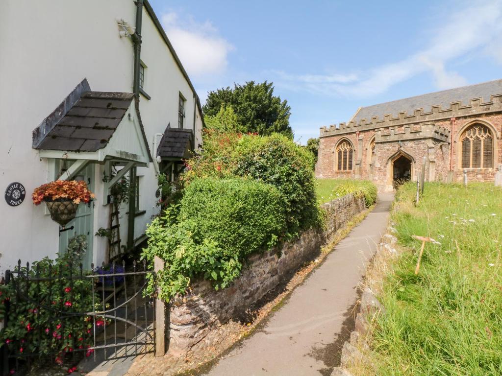 an old building and a path in front of a building at Castle View in Dunster