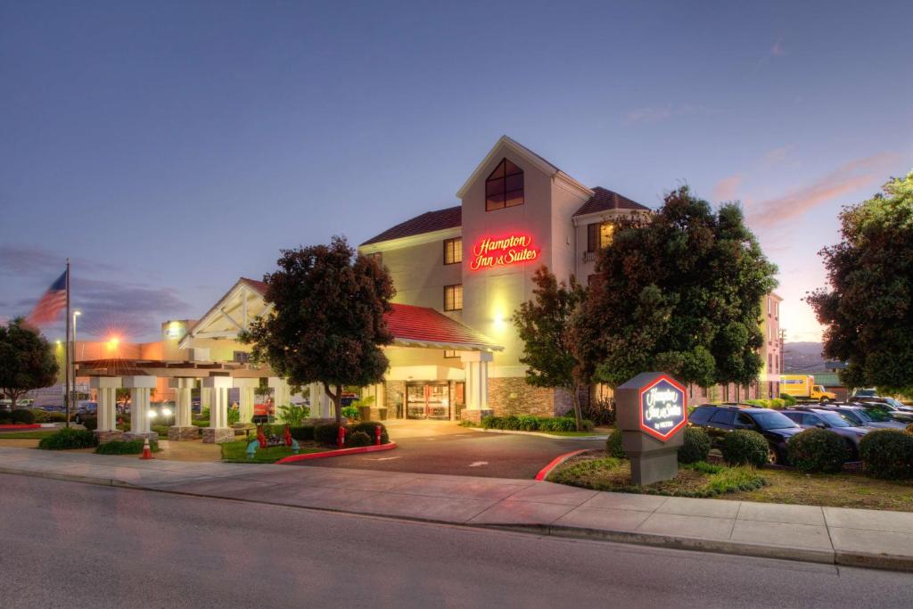 a hotel with cars parked in a parking lot at Hampton Inn & Suites San Francisco-Burlingame-Airport South in Burlingame