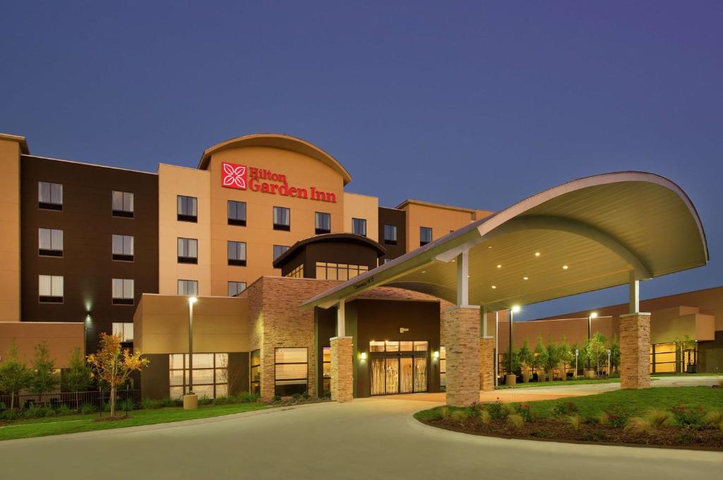 a hospital building with an arch in front of it at Hilton Garden Inn College Station in College Station