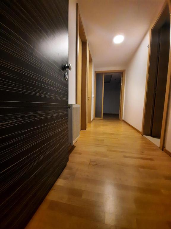 een hal met een deur en een houten vloer bij Luxurios Apartment Sarajevo in Sarajevo