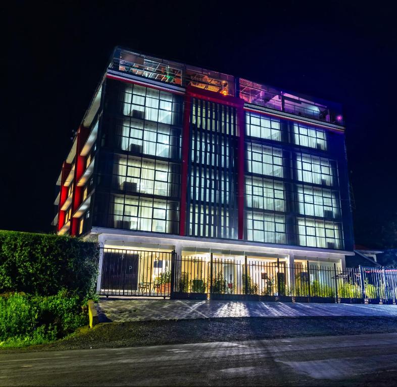 - un grand bâtiment avec des fenêtres éclairées la nuit dans l'établissement Muthu Warwick Mount Kenya Hotel, Nanyuki, à Nanyuki