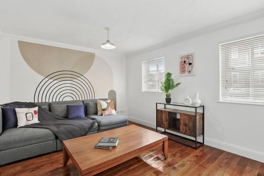a living room with a couch and a coffee table at East End 1 Bed W/ Gated Parking in London