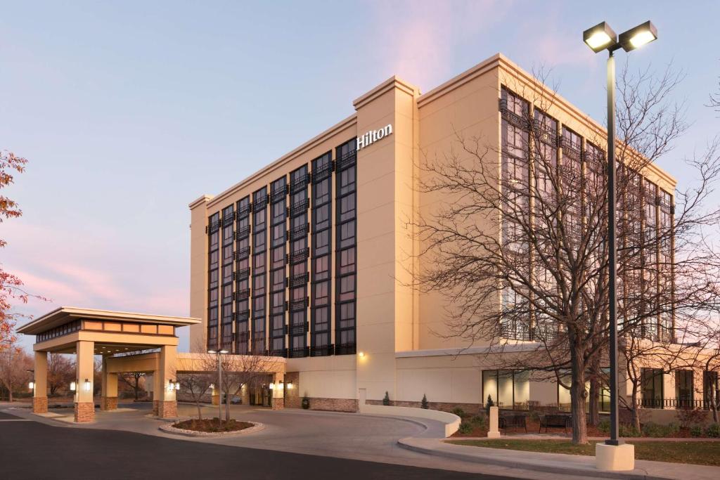 a building with a street light in front of it at Hilton Fort Collins in Fort Collins