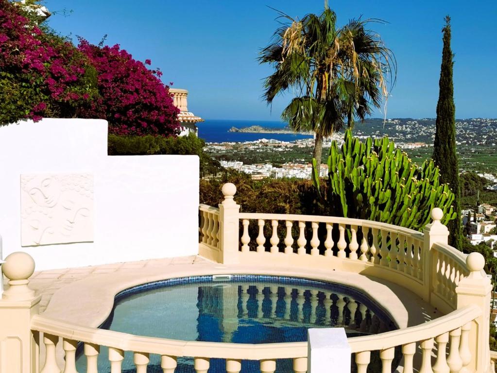 a swimming pool in a balcony with a fence at Villa Panorama in Jávea