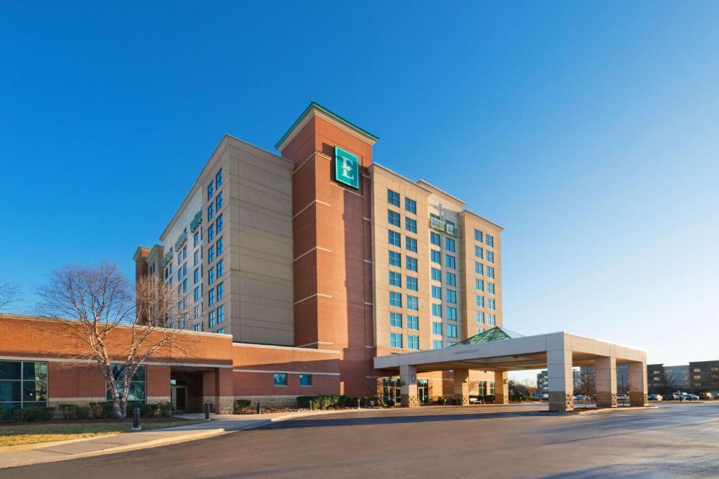 a large building with a clock on top of it at Embassy Suites Murfreesboro - Hotel & Conference Center in Murfreesboro