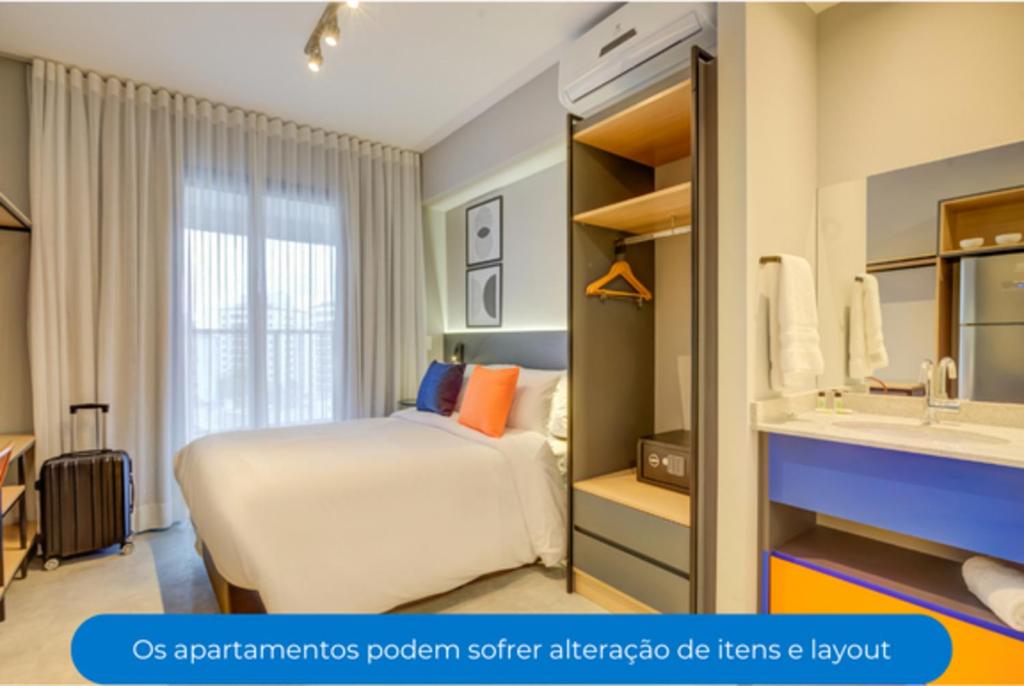 a hotel room with a bed and a sink at Roomo Vila Mariana Vergueiro Residencial in Sao Paulo