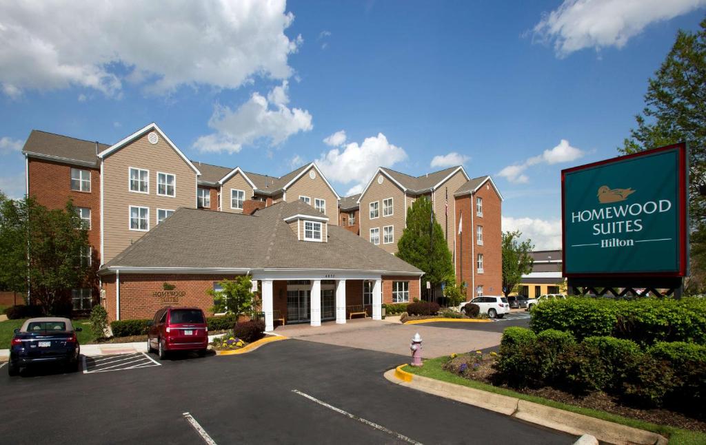 um sinal num parque de estacionamento em frente a um hotel em Homewood Suites by Hilton Alexandria em Alexandria