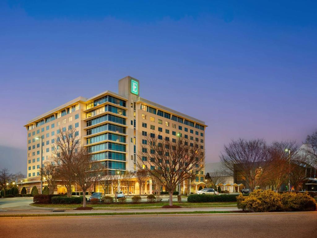 a large building with a clock on top of it at Embassy Suites by Hilton Hampton Convention Center in Hampton