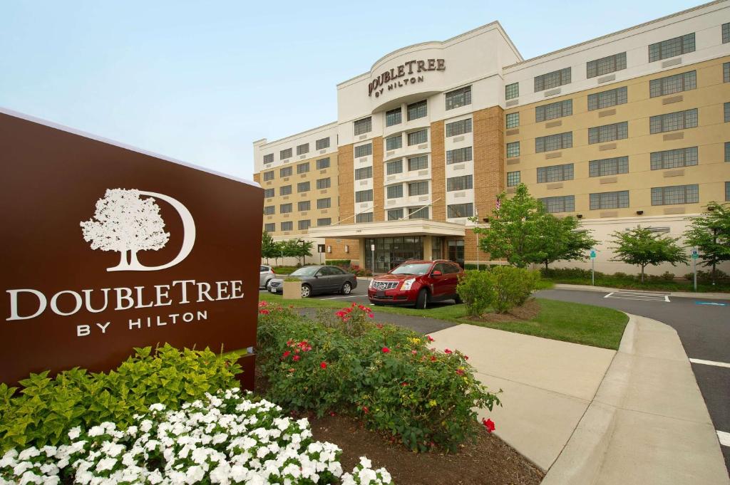 a hotel sign in front of a building at DoubleTree by Hilton Dulles Airport-Sterling in Sterling