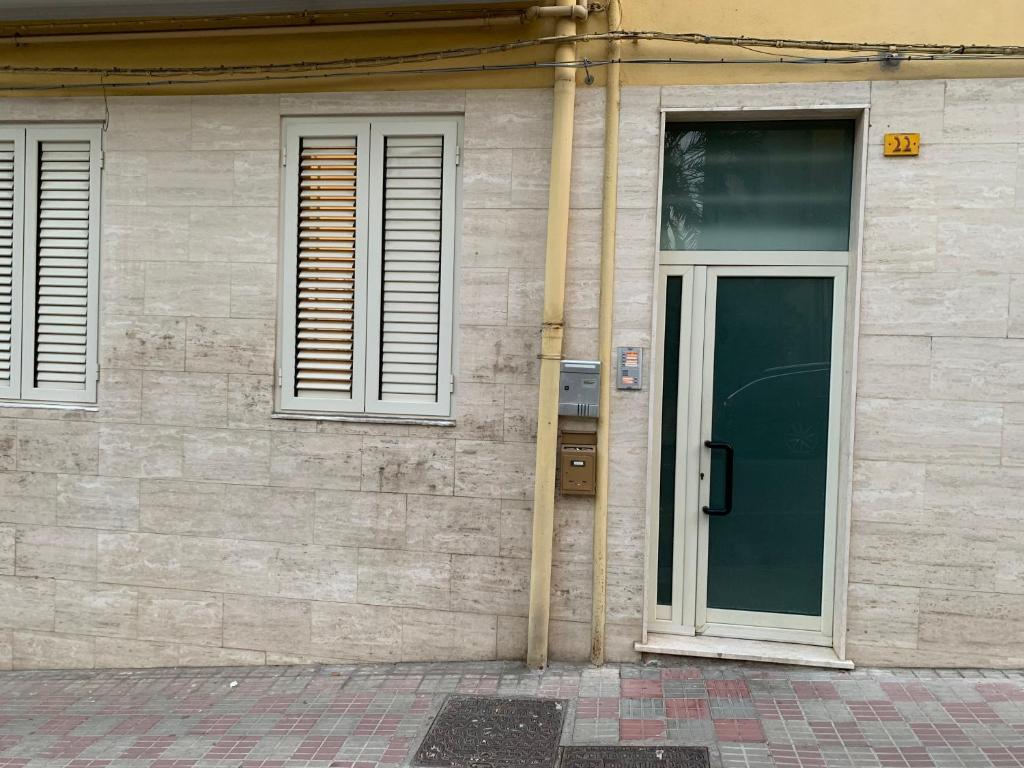 a building with a door and windows on it at KIKA HOUSE in Cagliari