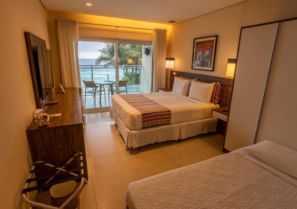 Cama ou camas em um quarto em Amora Hotel Maresias
