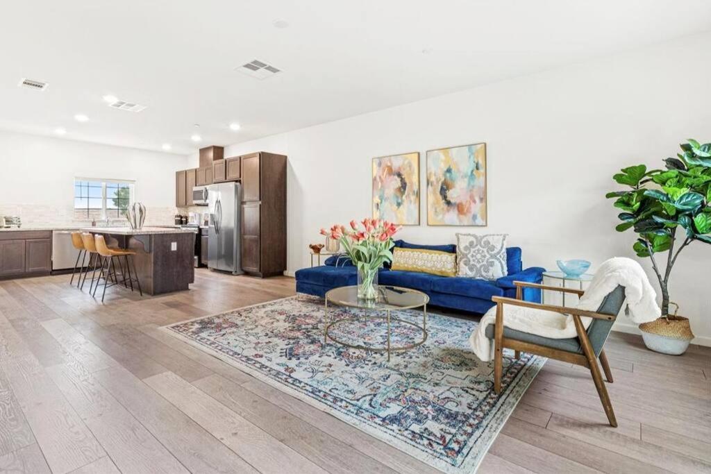 a living room with a blue couch and a table at Only available on other site in Sacramento