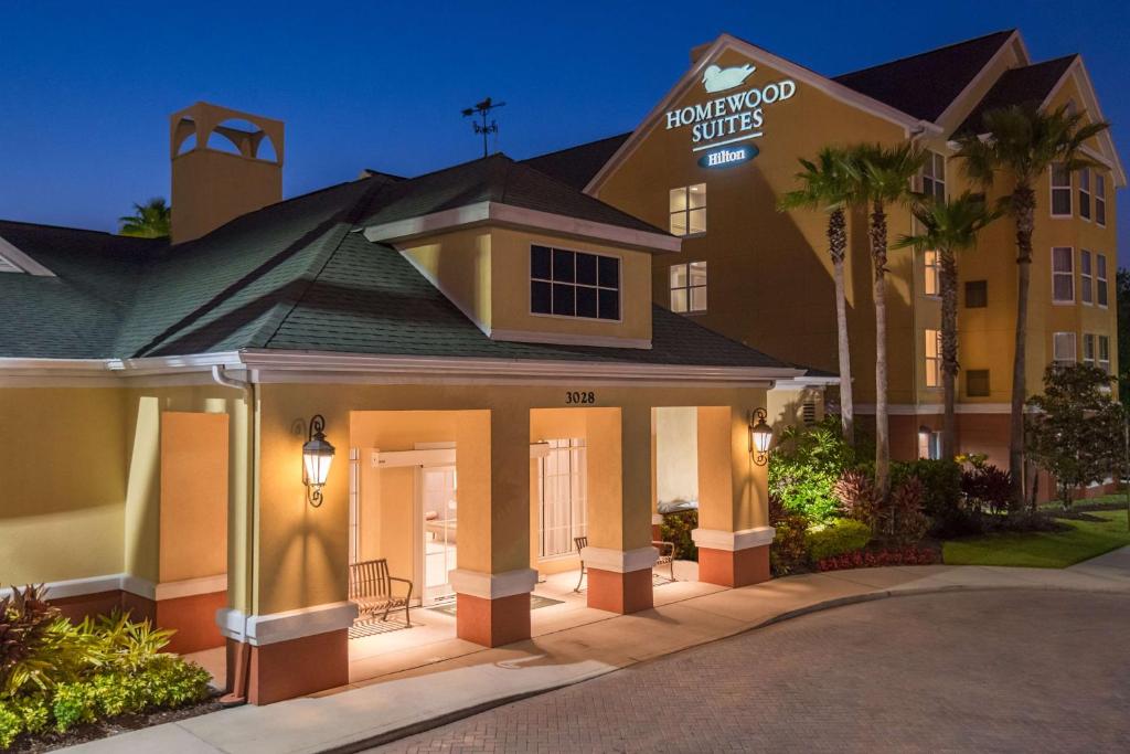 a hotel with a sign on the front of it at Homewood Suites by Hilton Orlando-UCF Area in Orlando