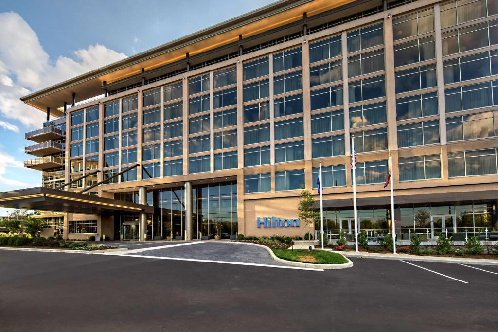 a large building with a parking lot in front of it at Hilton Franklin Cool Springs in Franklin