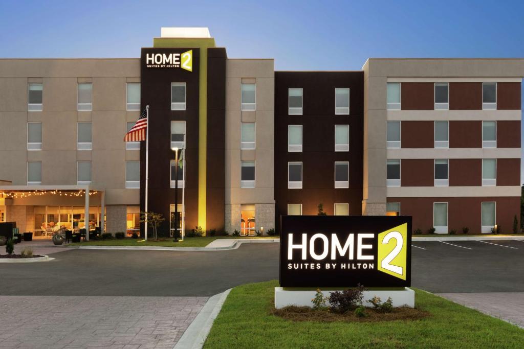 a hotel sign in front of a building at Home2 Suites By Hilton Savannah Airport in Savannah