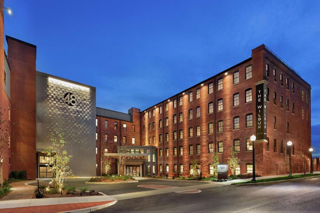 a large brick building in front of a street at The Wilbur Lititz, Tapestry Collection By Hilton in Lititz