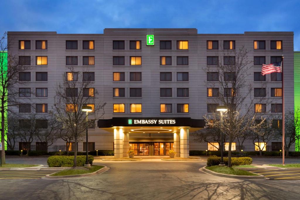 a hotel with a green sign on the front of it at Embassy Suites by Hilton Chicago North Shore Deerfield in Deerfield