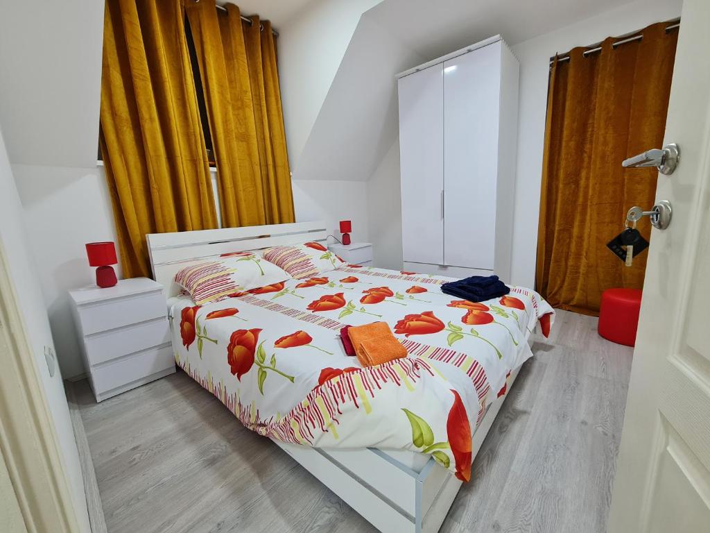 ein Schlafzimmer mit einem Bett mit orange-weißer Bettwäsche in der Unterkunft RM Festival Rooms Guca in Guča