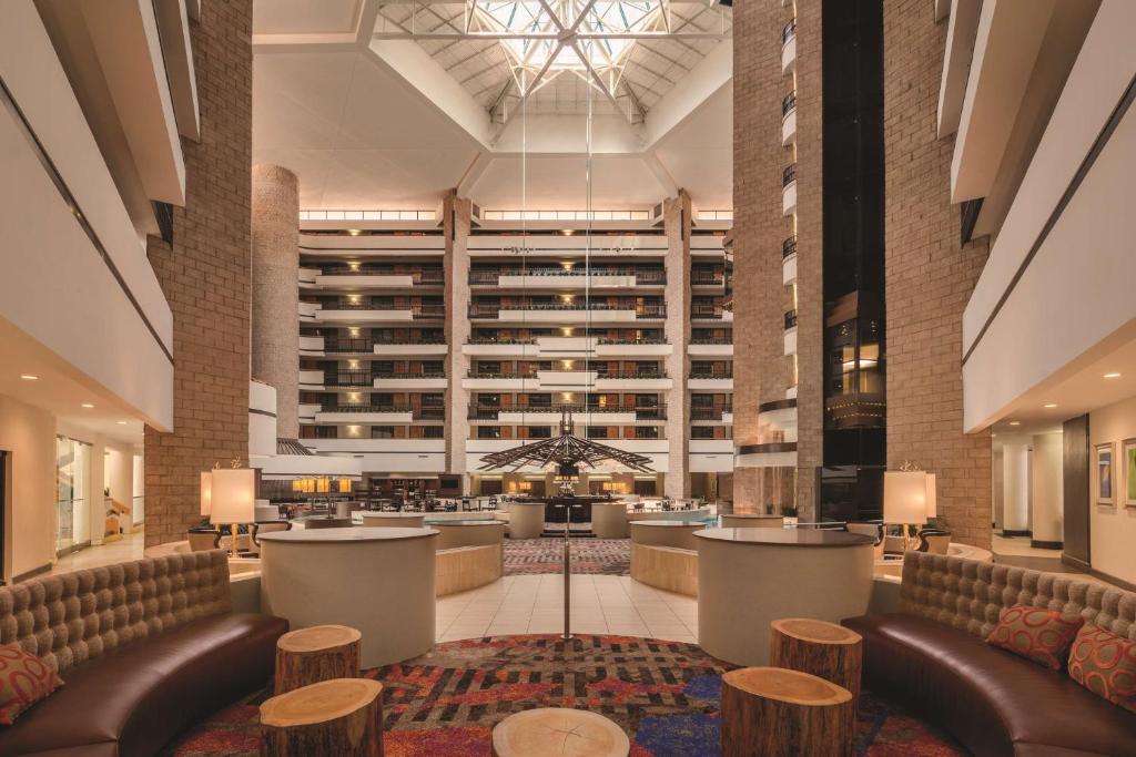 a lobby of a hotel with couches and tables at Embassy Suites by Hilton Orlando International Drive ICON Park in Orlando