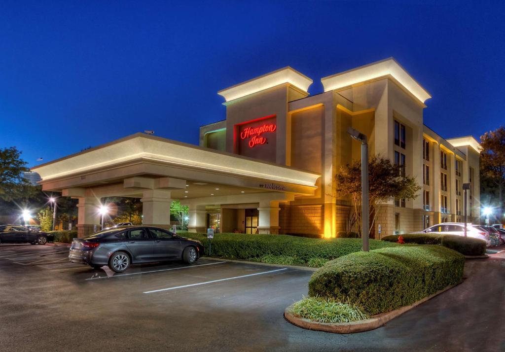 a hotel with a car parked in a parking lot at Hampton Inn Memphis Poplar in Memphis