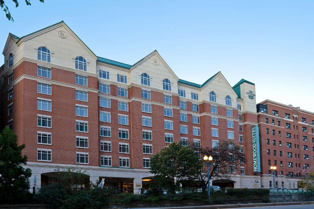 a large red brick building on a city street at Homewood Suites by Hilton Washington, D.C. Downtown in Washington