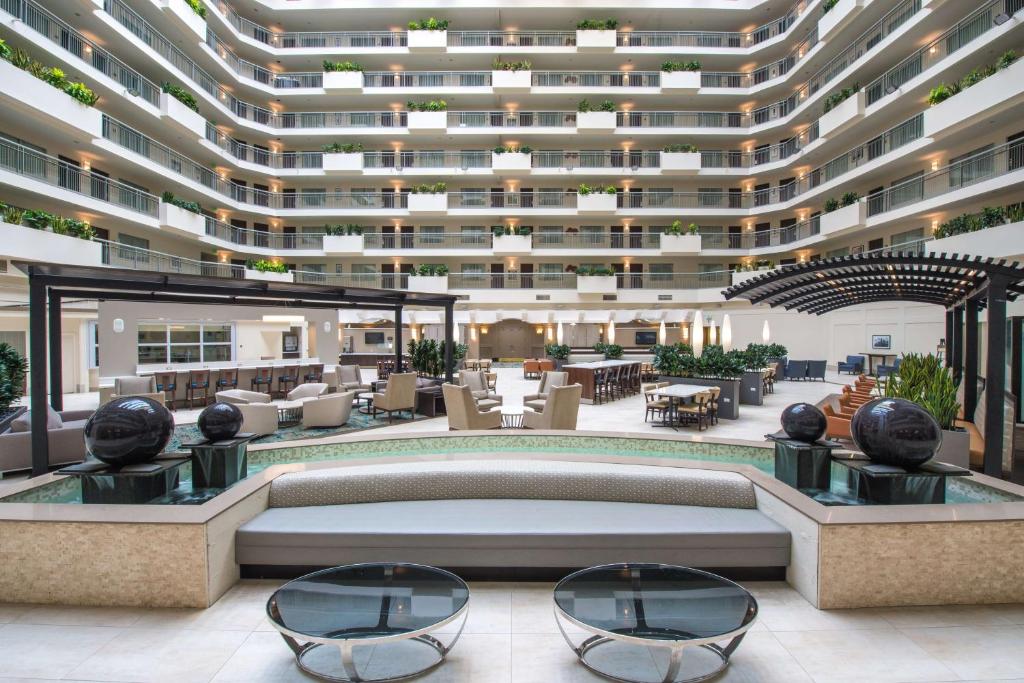 a rendering of a hotel lobby with a large building at Embassy Suites By Hilton Seattle - Tacoma International Airport in Tukwila
