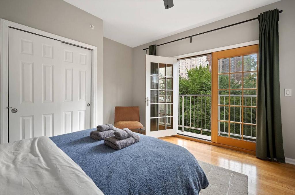a bedroom with a bed and a large window at StayRafa At 261 4R in Philadelphia