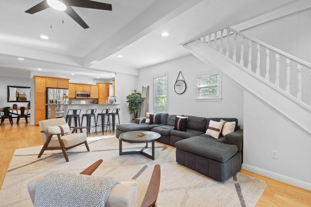 a living room with a couch and a table at Blissful Boyne City Retreat: Luxurious & Modern! Sleeps 15! in Boyne City