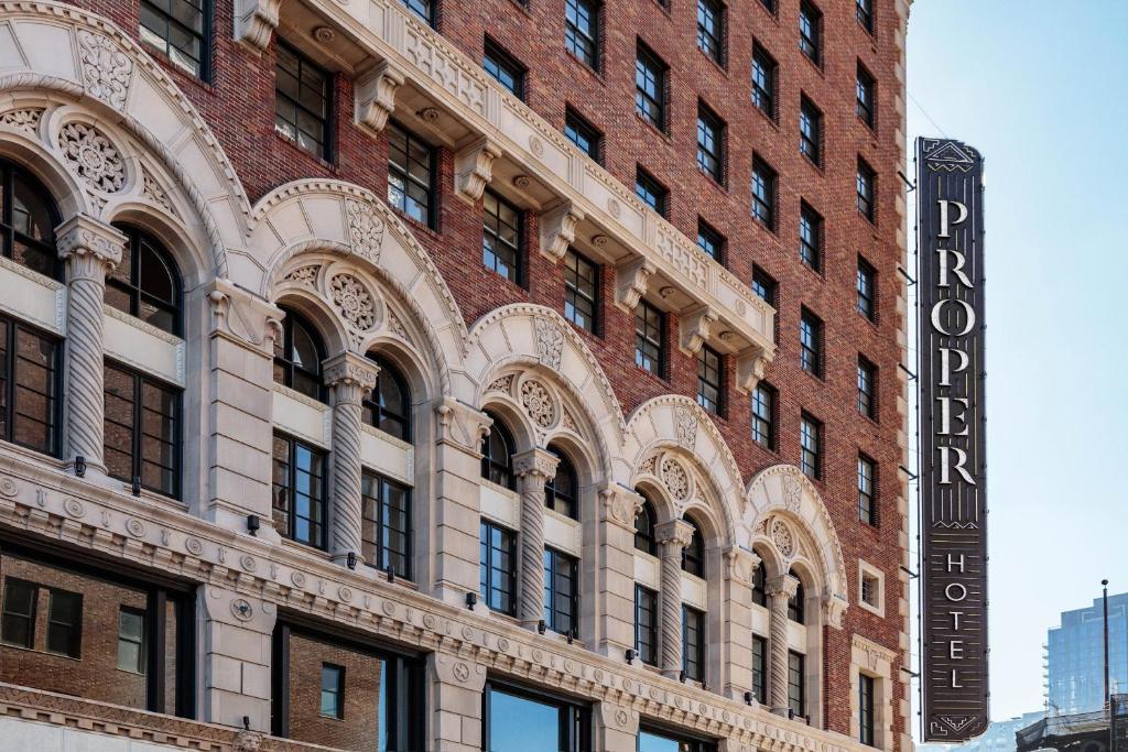 a brick building with a sign on the side of it at Downtown Los Angeles Proper Hotel, a Member of Design Hotels in Los Angeles