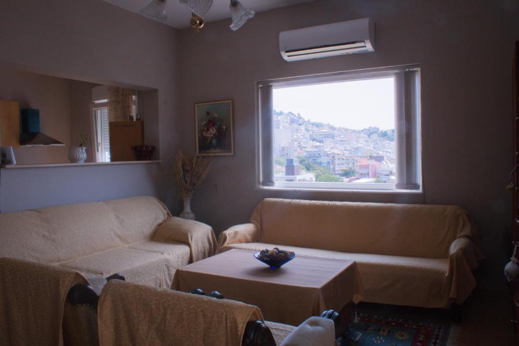 a living room with two couches and a window at Your Holiday Apartment in Kavála