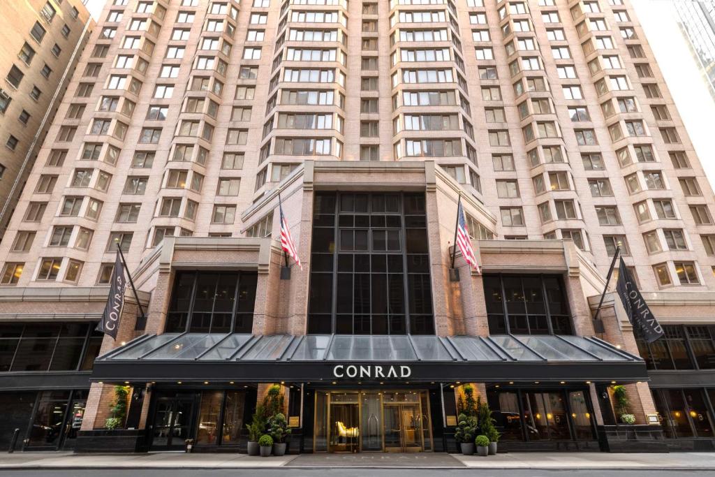a rendering of the comnd hotel in front of a tall building at Conrad New York Midtown in New York